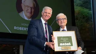 Robert Hirsch accepts Reflections Award from CEO and President Dale Surowitz