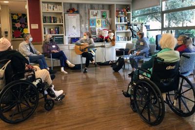 Group listens to guitar.