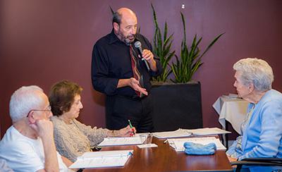 Elderly listening to a speaker