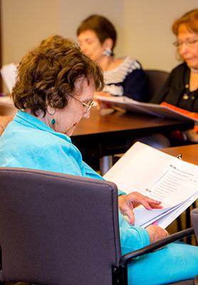 Old woman reading a paper
