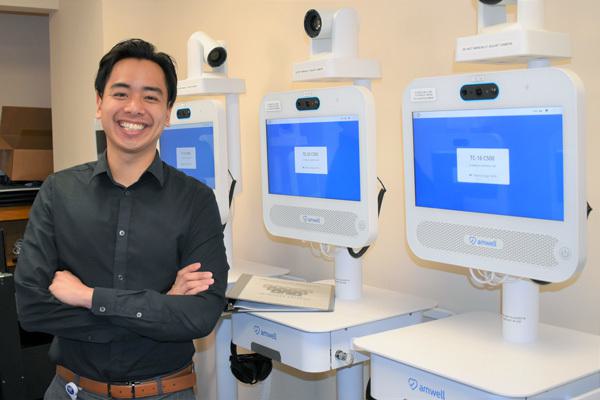 Anton Domingo beside telehealth stations